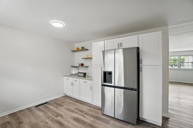 273 E Alcott Rd, Columbus, OH 43207 - kitchen featuring stainless steel fridge with ice dispenser, open shelves, light wood-style flooring, and white cabinetry