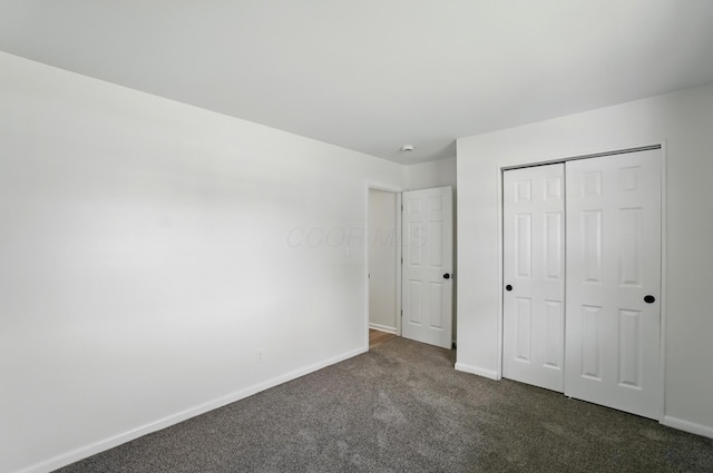 273 E Alcott Rd, Columbus, OH 43207 - unfurnished bedroom featuring dark carpet, baseboards, and a closet