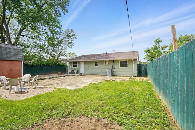 273 E Alcott Rd, Columbus, OH 43207 - rear view of house featuring a patio area, an outbuilding, a storage unit, and central AC
