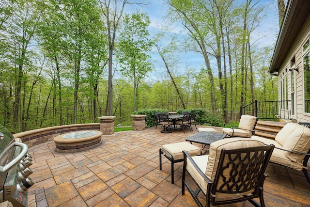 view of patio featuring outdoor dining space and an outdoor fire pit