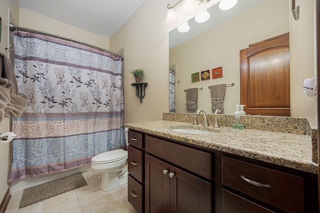 bathroom with toilet, tile patterned floors, vanity, and shower / bath combo with shower curtain