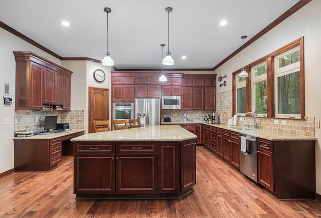 kitchen with appliances with stainless steel finishes, a sink, ornamental molding, tasteful backsplash, and wood finished floors