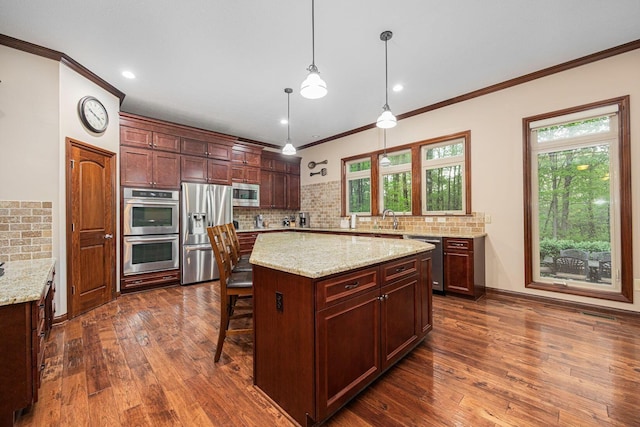 kitchen with appliances with stainless steel finishes, tasteful backsplash, ornamental molding, healthy amount of natural light, and dark wood-style flooring