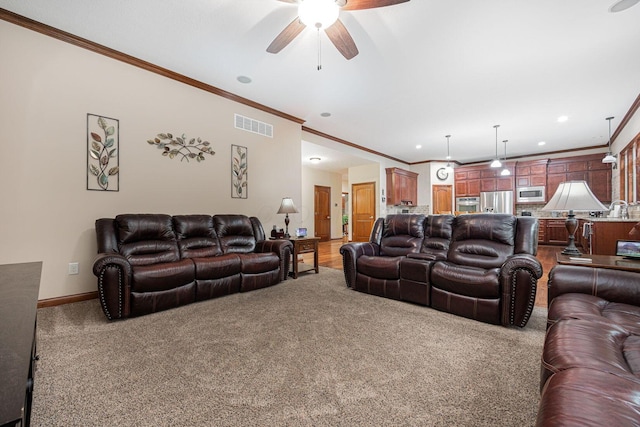 living room featuring crown molding, carpet, a ceiling fan, baseboards, and recessed lighting
