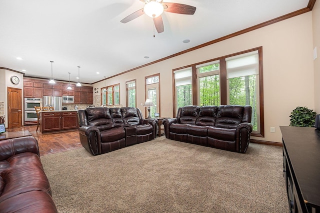 living room with crown molding, a ceiling fan, recessed lighting, baseboards, and dark colored carpet