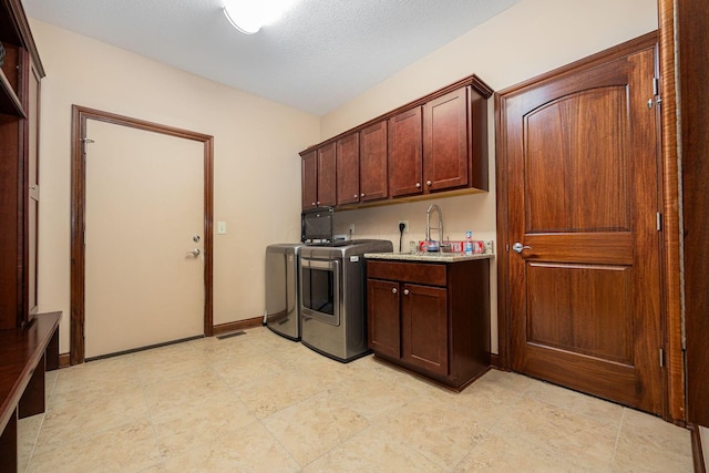 laundry area with independent washer and dryer and cabinet space
