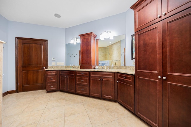 bathroom featuring tiled shower, tile patterned floors, and double vanity