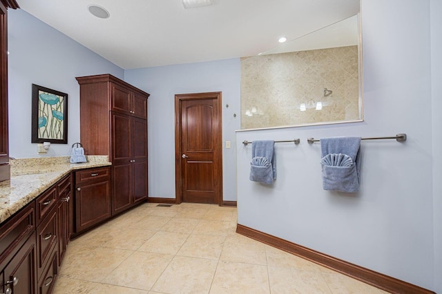 full bathroom featuring baseboards, vanity, and tile patterned floors