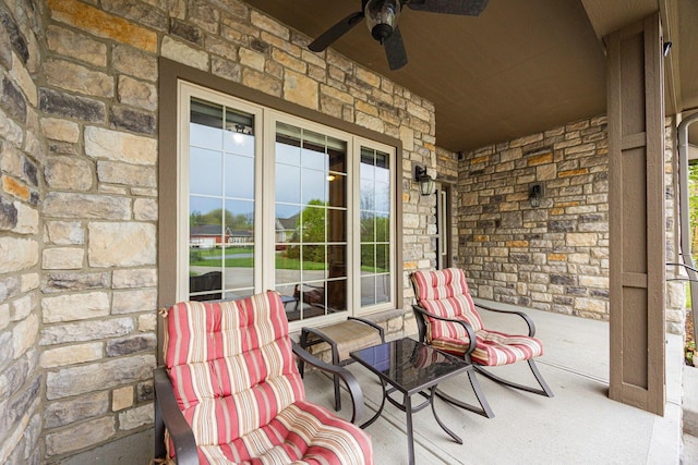 view of patio featuring a ceiling fan and a porch