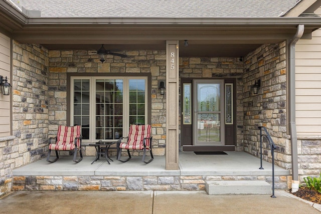 doorway to property with covered porch and stone siding