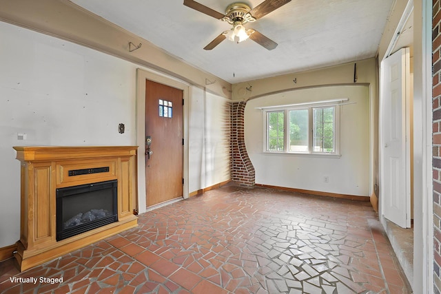 5 Baltimore Somerset Rd NE, Baltimore, OH 43105 - unfurnished living room featuring baseboards, ceiling fan, and a glass covered fireplace