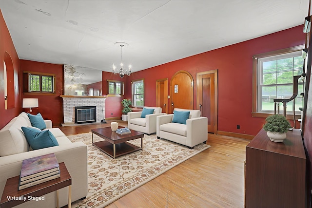 5 Baltimore Somerset Rd NE, Baltimore, OH 43105 - living room featuring light wood-type flooring, a chandelier, a fireplace, and baseboards
