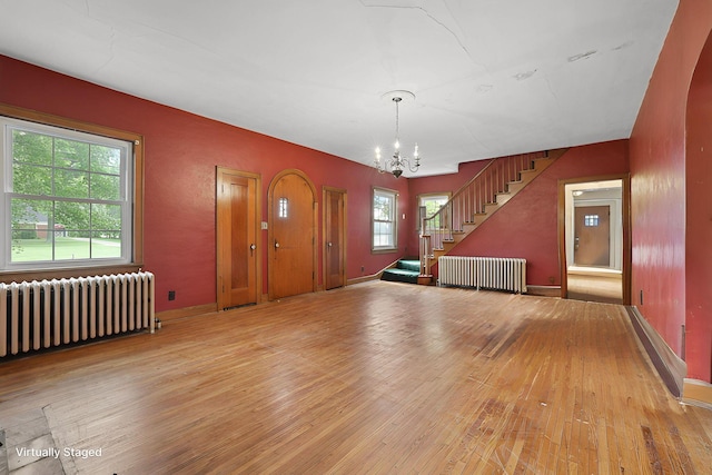 5 Baltimore Somerset Rd NE, Baltimore, OH 43105 - entryway featuring radiator, a chandelier, light wood-style floors, stairway, and baseboards