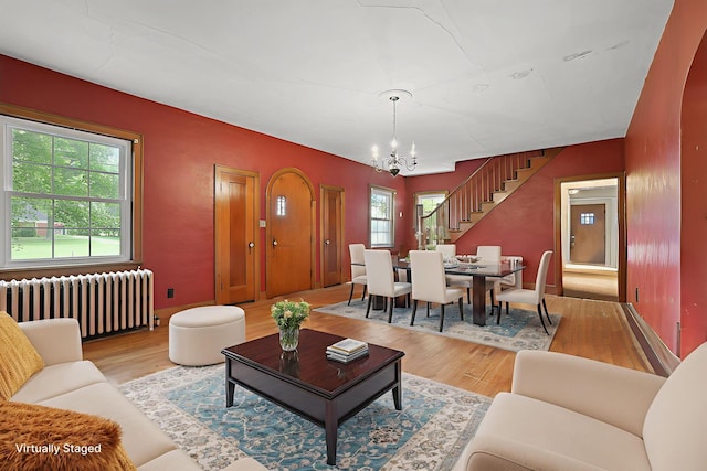 5 Baltimore Somerset Rd NE, Baltimore, OH 43105 - living room with radiator heating unit, a chandelier, light wood-style floors, stairway, and baseboards