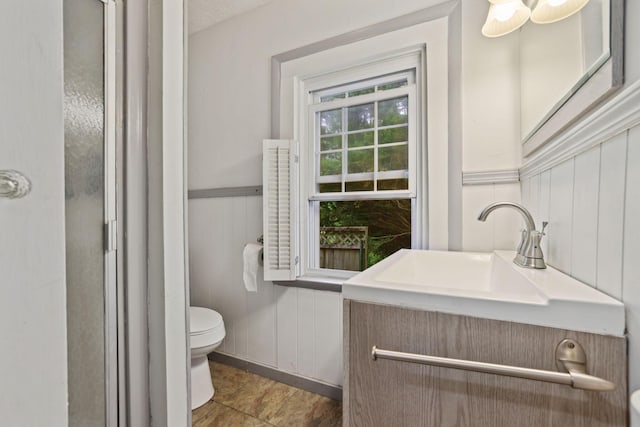 5 Baltimore Somerset Rd NE, Baltimore, OH 43105 - bathroom with toilet, vanity, a shower stall, wainscoting, and a decorative wall