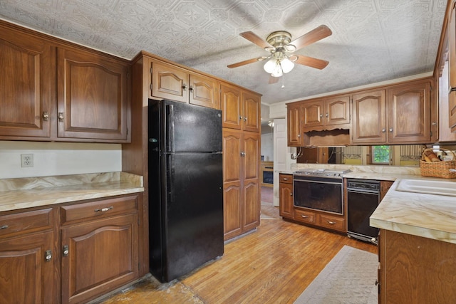 5 Baltimore Somerset Rd NE, Baltimore, OH 43105 - kitchen featuring freestanding refrigerator, ceiling fan, light countertops, light wood finished floors, and a sink
