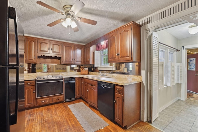 5 Baltimore Somerset Rd NE, Baltimore, OH 43105 - kitchen with black appliances, light countertops, a sink, ceiling fan, and an ornate ceiling