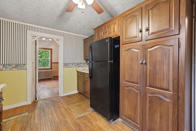 5 Baltimore Somerset Rd NE, Baltimore, OH 43105 - kitchen with freestanding refrigerator, radiator heating unit, light wood-type flooring, baseboards, and a ceiling fan