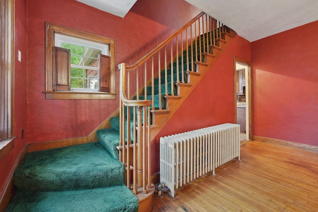 5 Baltimore Somerset Rd NE, Baltimore, OH 43105 - staircase with radiator heating unit, wood finished floors, baseboards, and a textured wall