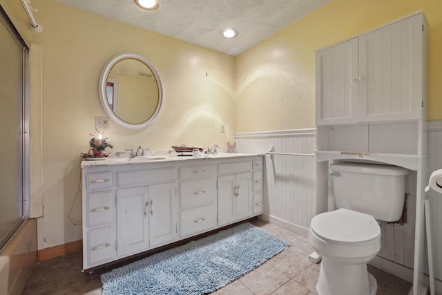 5 Baltimore Somerset Rd NE, Baltimore, OH 43105 - full bathroom with double vanity, toilet, wainscoting, a shower, and tile patterned flooring