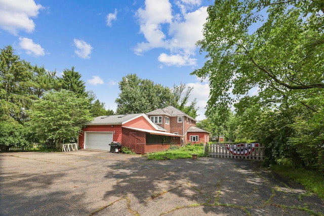 5 Baltimore Somerset Rd NE, Baltimore, OH 43105 - view of front of home with asphalt driveway, an attached garage, and a gate