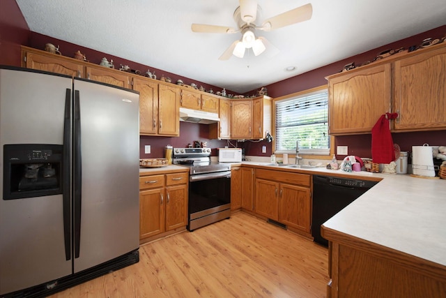 134 Hasbrouck Cir, Howard, OH 43028 - kitchen featuring appliances with stainless steel finishes, a sink, under cabinet range hood, and light wood-style flooring