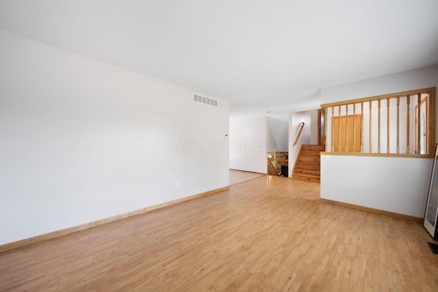 134 Hasbrouck Cir, Howard, OH 43028 - unfurnished living room with stairs, wood finished floors, and baseboards
