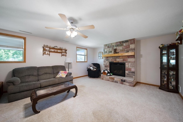 134 Hasbrouck Cir, Howard, OH 43028 - carpeted living area featuring a stone fireplace, a ceiling fan, and baseboards