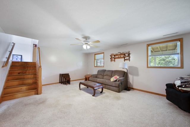 134 Hasbrouck Cir, Howard, OH 43028 - carpeted living room with baseboards, ceiling fan, and stairway