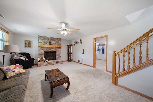134 Hasbrouck Cir, Howard, OH 43028 - living area featuring a ceiling fan, carpet floors, stairway, baseboards, and a stone fireplace