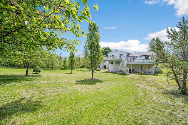 134 Hasbrouck Cir, Howard, OH 43028 - view of green lawn with a wooden deck and stairway