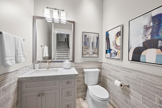 7347 Lambton Park Rd, New Albany, OH 43054 - bathroom with tile walls, toilet, wainscoting, vanity, and tile patterned flooring