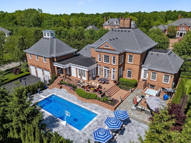 7347 Lambton Park Rd, New Albany, OH 43054 - rear view of property featuring an outdoor pool, french doors, a patio area, entry steps, and a shingled roof