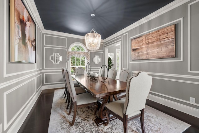 7347 Lambton Park Rd, New Albany, OH 43054 - dining space featuring a decorative wall, a chandelier, ornamental molding, wood finished floors, and baseboards