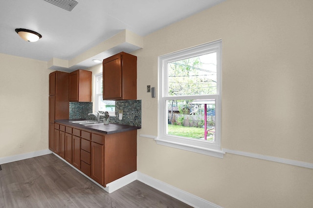 1666 Northridge Rd, Columbus, OH 43224 - kitchen featuring a sink, dark countertops, dark wood-style floors, and baseboards