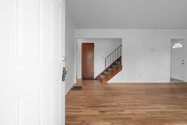 1666 Northridge Rd, Columbus, OH 43224 - foyer entrance featuring crown molding, stairs, wood finished floors, and baseboards