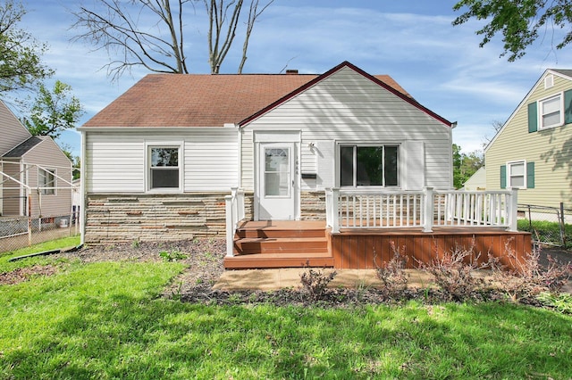 1666 Northridge Rd, Columbus, OH 43224 - back of property with a deck, stone siding, and a shingled roof