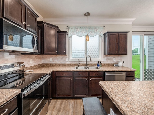 9035 Strawser St, Orient, OH 43146 - kitchen with stainless steel appliances, a sink, dark brown cabinetry, backsplash, and crown molding