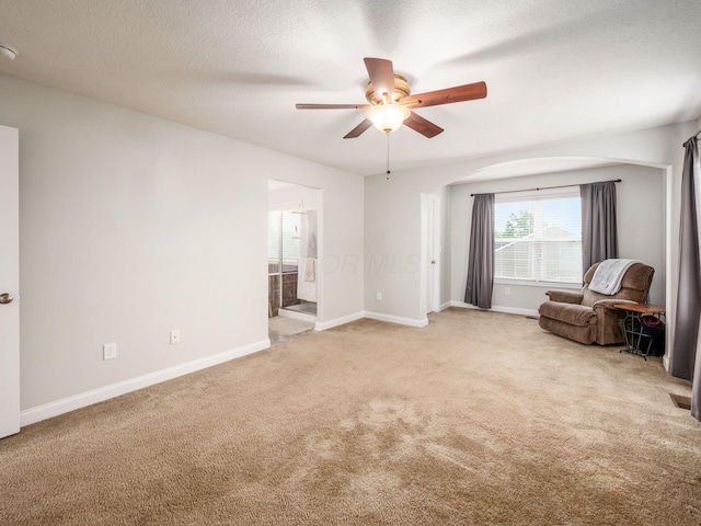 9035 Strawser St, Orient, OH 43146 - unfurnished room featuring light carpet, ceiling fan, baseboards, arched walkways, and a textured ceiling