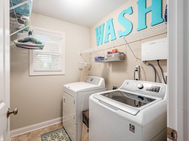 9035 Strawser St, Orient, OH 43146 - laundry area featuring washing machine and clothes dryer, baseboards, and light tile patterned flooring