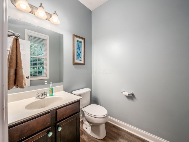 9035 Strawser St, Orient, OH 43146 - bathroom featuring toilet, vanity, wood finished floors, and baseboards