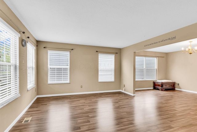 5556 Falco Dr, Westerville, OH 43081 - unfurnished room with wood finished floors, a chandelier, and baseboards