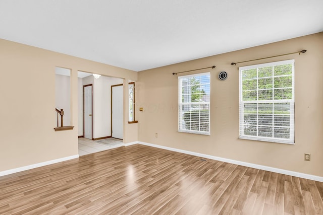 5556 Falco Dr, Westerville, OH 43081 - empty room with light wood-style floors, plenty of natural light, and baseboards