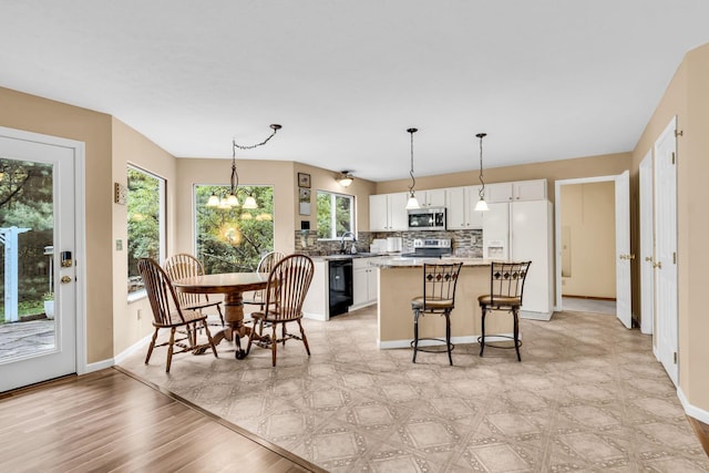 5556 Falco Dr, Westerville, OH 43081 - dining area featuring baseboards, a chandelier, and light floors