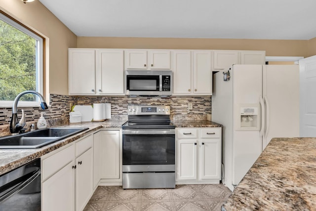 5556 Falco Dr, Westerville, OH 43081 - kitchen with stainless steel appliances, a sink, white cabinetry, and tasteful backsplash