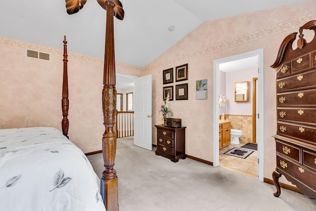 5556 Falco Dr, Westerville, OH 43081 - bedroom with vaulted ceiling, ensuite bath, baseboards, and light carpet