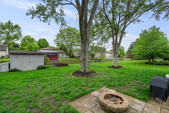 460 Lytton Way, Columbus, OH 43230 - view of yard featuring an outdoor fire pit, a storage unit, an outbuilding, and a patio