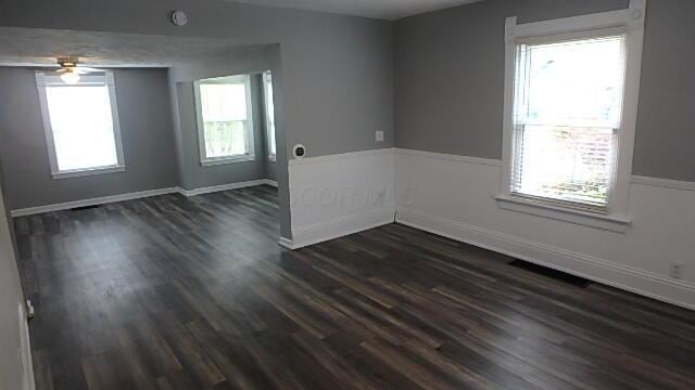43 Oak St, Delaware, OH 43015 - spare room featuring plenty of natural light, dark wood-type flooring, ceiling fan, and baseboards