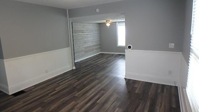 43 Oak St, Delaware, OH 43015 - unfurnished room featuring healthy amount of natural light, dark wood-style flooring, a ceiling fan, and baseboards