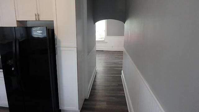 43 Oak St, Delaware, OH 43015 - hall featuring arched walkways, dark wood finished floors, and wainscoting